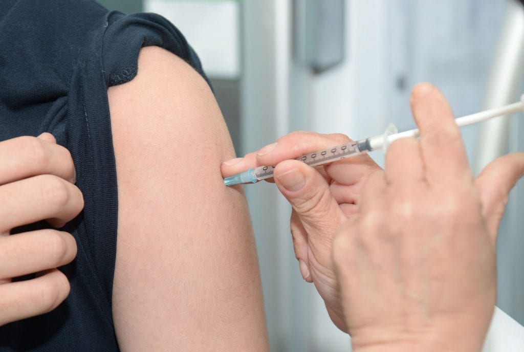 medical professional administering an influenza vaccine