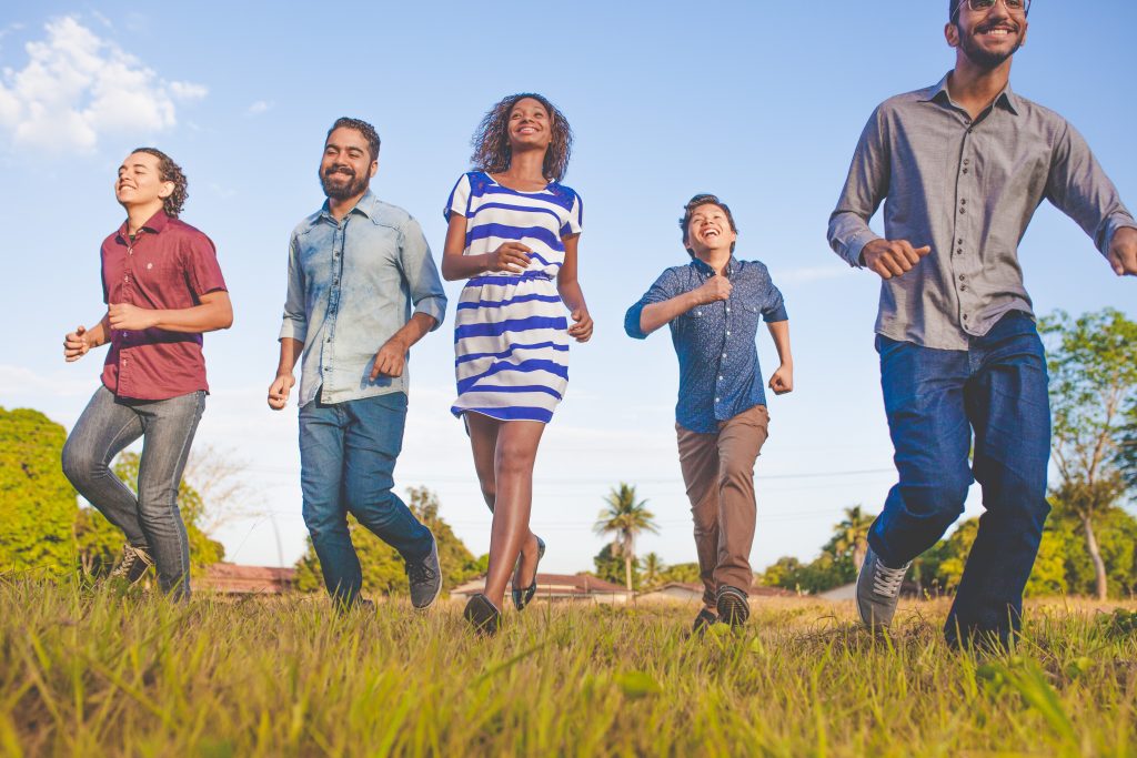 Five people jogging and smiling