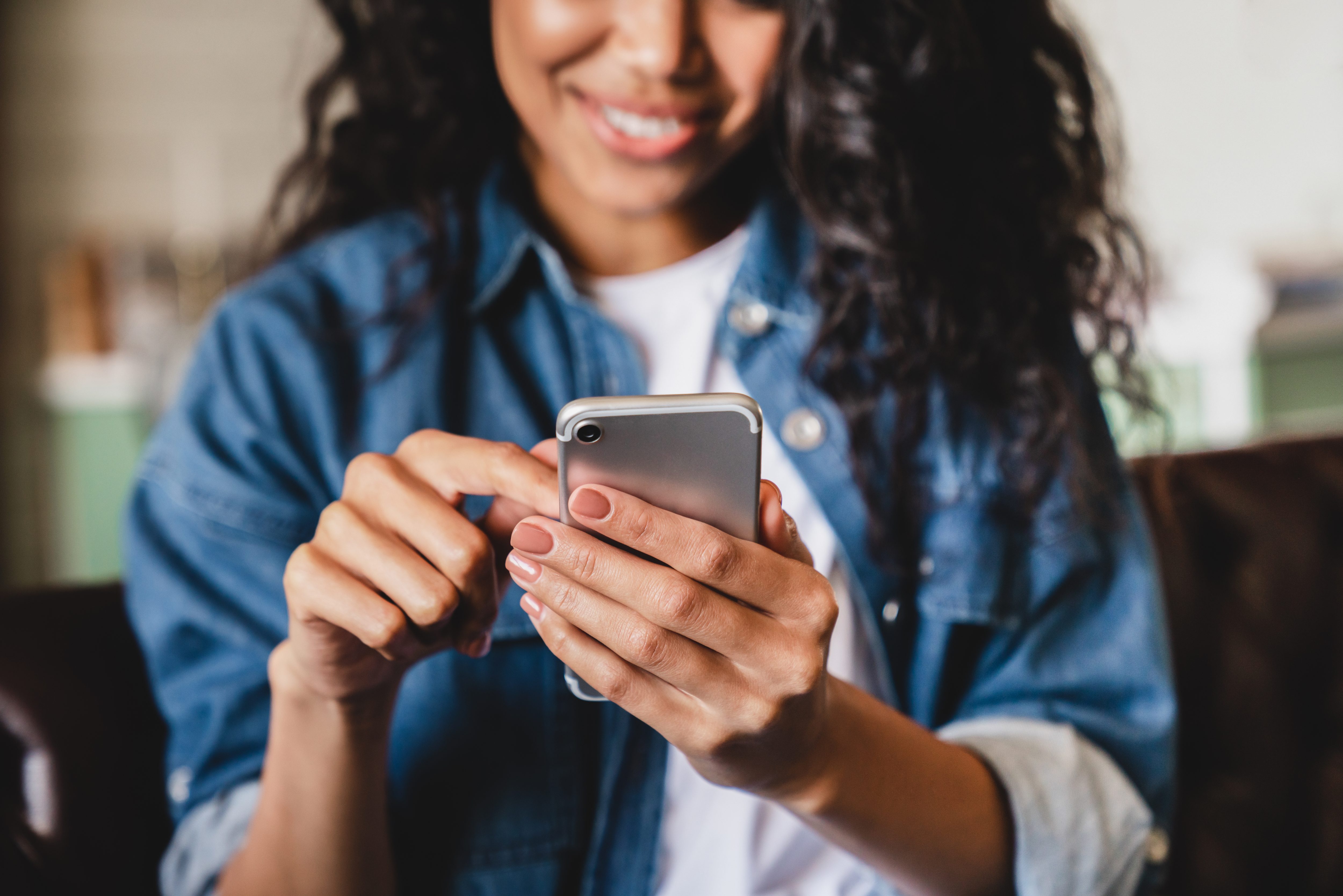 young woman using smart phone at home.