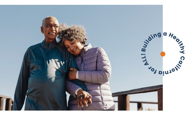 Building a healthy California for all. Senior couple walking on a pier.